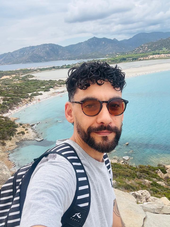 Rafael Sasso hiking above the coast of Villasimius, Sardinia